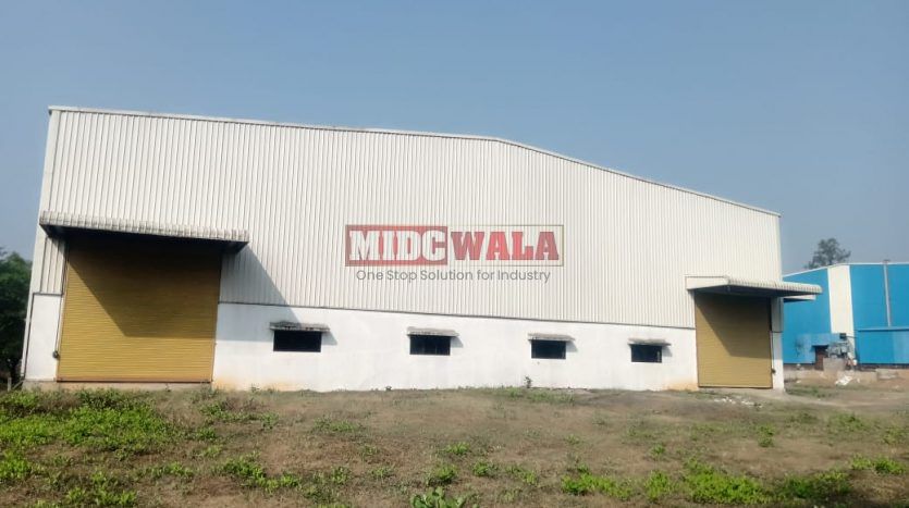 spacious and well-maintained industrial shed available for lease in Khopoli, Navi Mumbai's TTC Industrial Area. The shed features ample workspace, ample power supply, and convenient access to transportation.