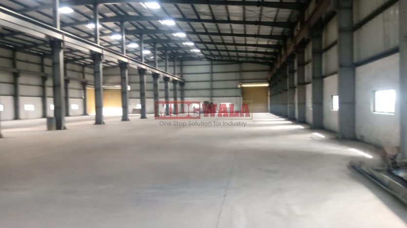 spacious and well-maintained industrial shed available for lease in Khopoli, Navi Mumbai's TTC Industrial Area. The shed features ample workspace, ample power supply, and convenient access to transportation.