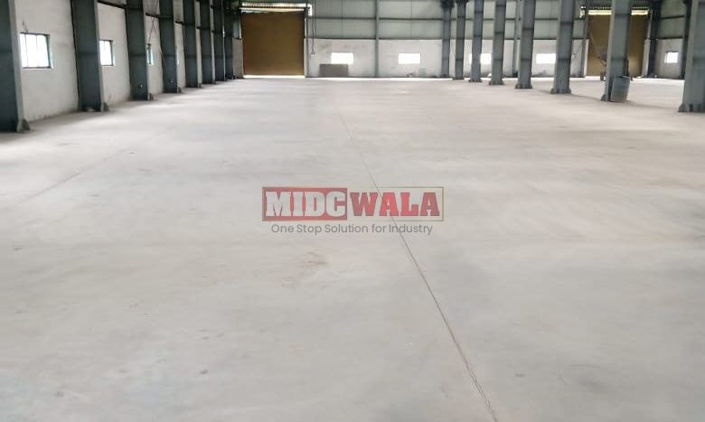 spacious and well-maintained industrial shed available for lease in Khopoli, Navi Mumbai's TTC Industrial Area. The shed features ample workspace, ample power supply, and convenient access to transportation.