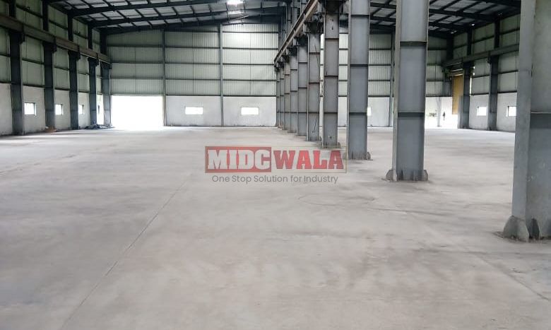 spacious and well-maintained industrial shed available for lease in Khopoli, Navi Mumbai's TTC Industrial Area. The shed features ample workspace, ample power supply, and convenient access to transportation.