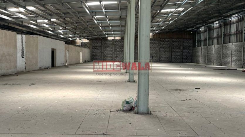 spacious and well-maintained industrial shed available for lease in Juinagar, Navi Mumbai's TTC Industrial Area. The shed features ample workspace, ample power supply, and convenient access to transportation.