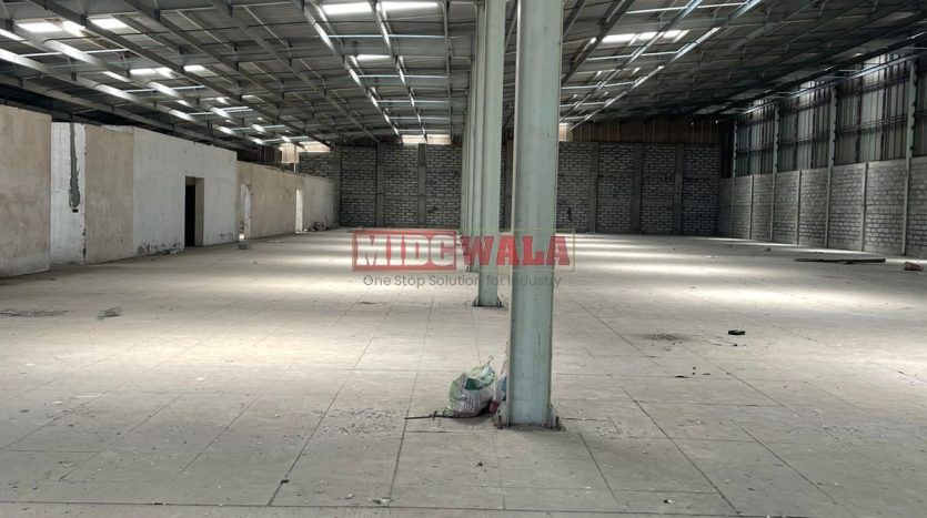 spacious and well-maintained industrial shed available for lease in Juinagar, Navi Mumbai's TTC Industrial Area. The shed features ample workspace, ample power supply, and convenient access to transportation.