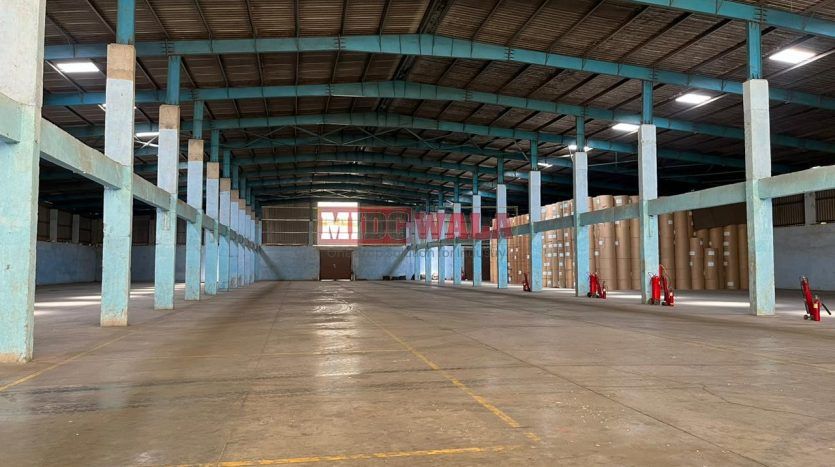 spacious and well-maintained industrial shed available for lease in Khopoli Khalapur, Navi Mumbai's TTC Industrial Area. The shed features ample workspace, ample power supply, and convenient access to transportation.