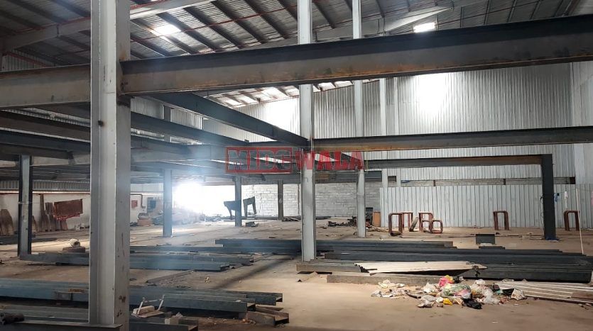 spacious and well-maintained industrial shed available for lease in Navi Mumbai's TTC Industrial Area. The shed features ample workspace, ample power supply, and convenient access to transportation.