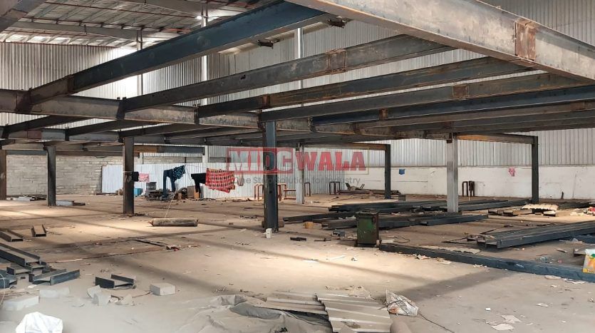 spacious and well-maintained industrial shed available for lease in Navi Mumbai's TTC Industrial Area. The shed features ample workspace, ample power supply, and convenient access to transportation.