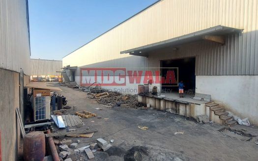 spacious and well-maintained industrial shed available for lease in Navi Mumbai's TTC Industrial Area. The shed features ample workspace, ample power supply, and convenient access to transportation.