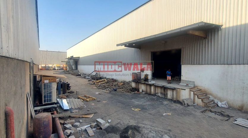 spacious and well-maintained industrial shed available for lease in Navi Mumbai's TTC Industrial Area. The shed features ample workspace, ample power supply, and convenient access to transportation.