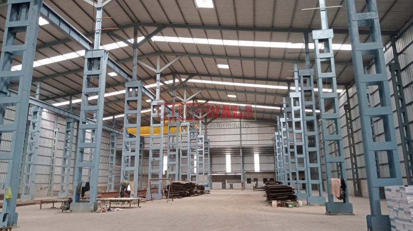 spacious and well-maintained industrial shed available for lease in Taloja, Navi Mumbai's TTC Industrial Area. The shed features ample workspace, ample power supply, and convenient access to transportation.