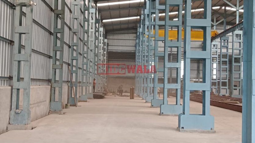 spacious and well-maintained industrial shed available for lease in Taloja, Navi Mumbai's TTC Industrial Area. The shed features ample workspace, ample power supply, and convenient access to transportation.