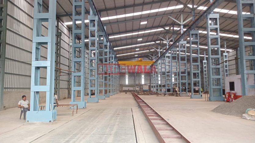 spacious and well-maintained industrial shed available for lease in Taloja, Navi Mumbai's TTC Industrial Area. The shed features ample workspace, ample power supply, and convenient access to transportation.