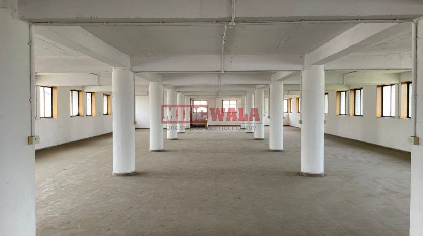 A spacious and modern industrial building available for lease in Navi Mumbai's Koper khairane Midc, TTC Industrial area. The building features abundant workspace, contemporary amenities, and a strategic location.