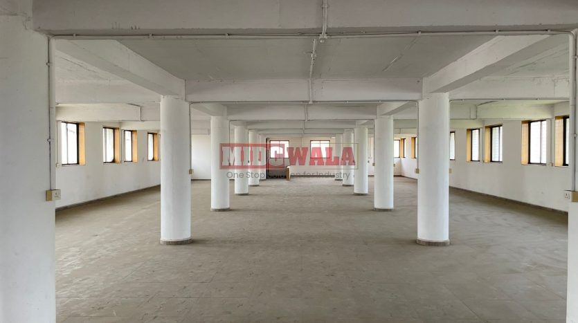 A spacious and modern industrial building available for lease in Navi Mumbai's Koper khairane Midc, TTC Industrial area. The building features abundant workspace, contemporary amenities, and a strategic location.