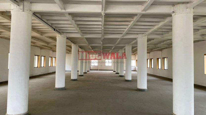 A spacious and modern industrial building available for lease in Navi Mumbai's Koper khairane Midc, TTC Industrial area. The building features abundant workspace, contemporary amenities, and a strategic location.