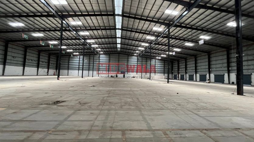 spacious and well-maintained industrial shed available for lease in Bhiwandi Thane Mumbai's TTC Industrial Area. The shed features ample workspace, ample power supply, and convenient access to transportation.