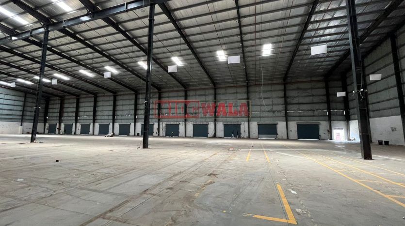 spacious and well-maintained industrial shed available for lease in Bhiwandi Thane Mumbai's TTC Industrial Area. The shed features ample workspace, ample power supply, and convenient access to transportation.