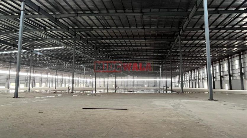 spacious and well-maintained industrial shed available for lease in Bhiwandi Thane Mumbai's TTC Industrial Area. The shed features ample workspace, ample power supply, and convenient access to transportation.