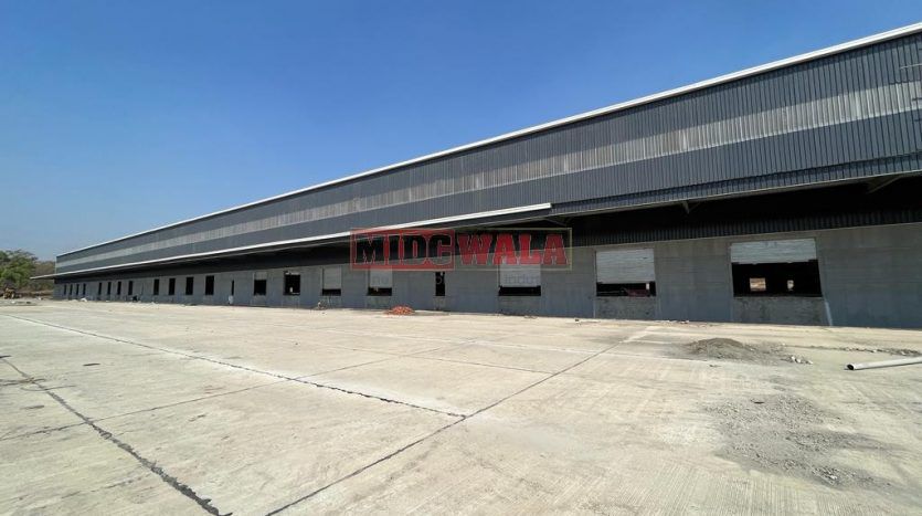 spacious and well-maintained industrial shed available for lease in Bhiwandi Thane Mumbai's TTC Industrial Area. The shed features ample workspace, ample power supply, and convenient access to transportation.