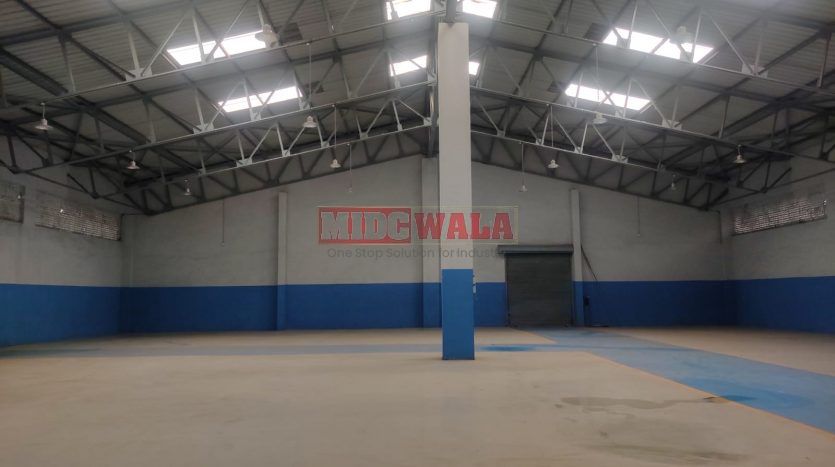 spacious and well-maintained industrial shed available for lease in Panvel, Navi Mumbai's TTC Industrial Area. The shed features ample workspace, ample power supply, and convenient access to transportation.