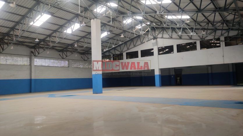 spacious and well-maintained industrial shed available for lease in Panvel, Navi Mumbai's TTC Industrial Area. The shed features ample workspace, ample power supply, and convenient access to transportation.