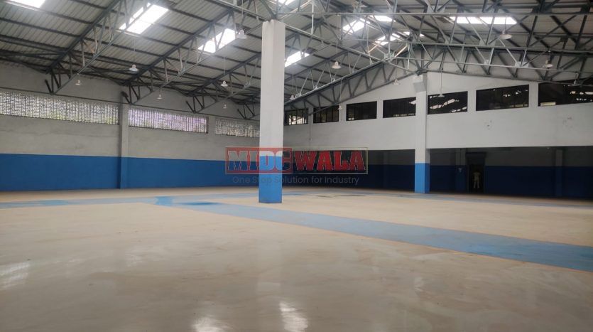 spacious and well-maintained industrial shed available for lease in Panvel, Navi Mumbai's TTC Industrial Area. The shed features ample workspace, ample power supply, and convenient access to transportation.