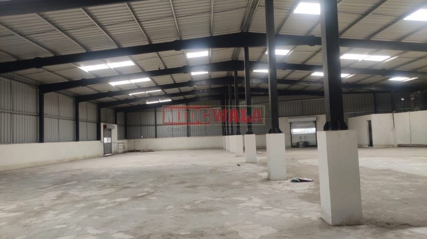 spacious and well-maintained industrial shed available for lease in Panvel, Navi Mumbai's TTC Industrial Area. The shed features ample workspace, ample power supply, and convenient access to transportation.