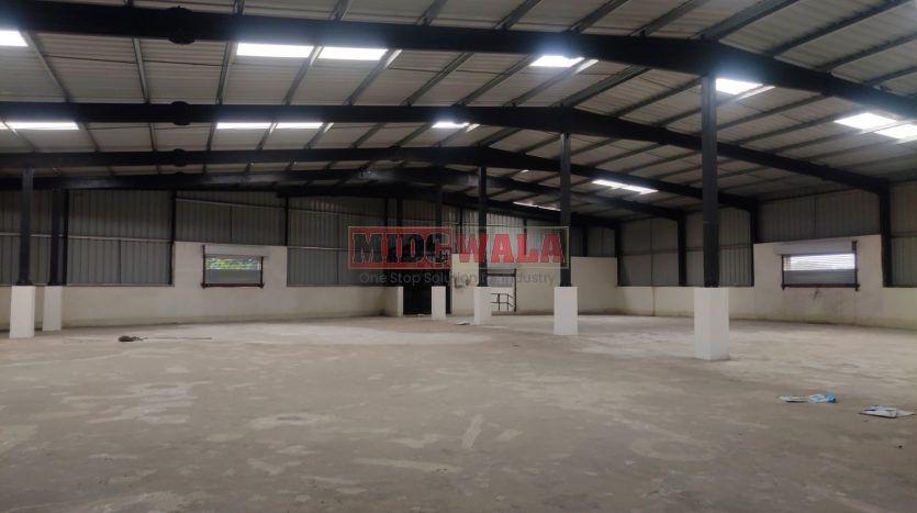 spacious and well-maintained industrial shed available for lease in Panvel, Navi Mumbai's TTC Industrial Area. The shed features ample workspace, ample power supply, and convenient access to transportation.