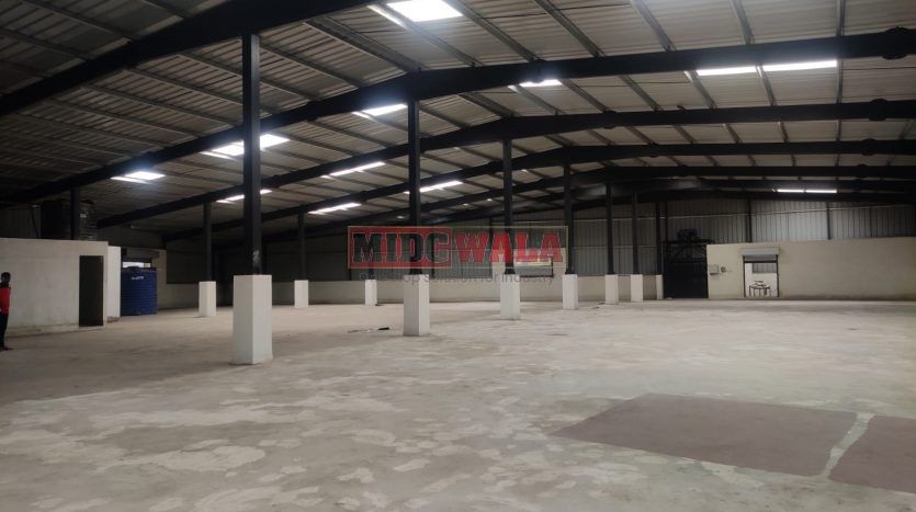 spacious and well-maintained industrial shed available for lease in Panvel, Navi Mumbai's TTC Industrial Area. The shed features ample workspace, ample power supply, and convenient access to transportation.