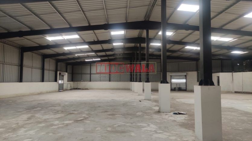 spacious and well-maintained industrial shed available for lease in Panvel, Navi Mumbai's TTC Industrial Area. The shed features ample workspace, ample power supply, and convenient access to transportation.