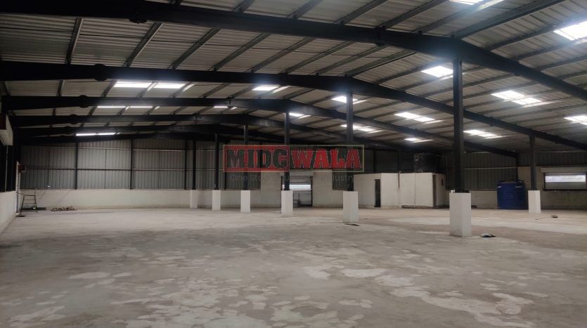 spacious and well-maintained industrial shed available for lease in Panvel, Navi Mumbai's TTC Industrial Area. The shed features ample workspace, ample power supply, and convenient access to transportation.