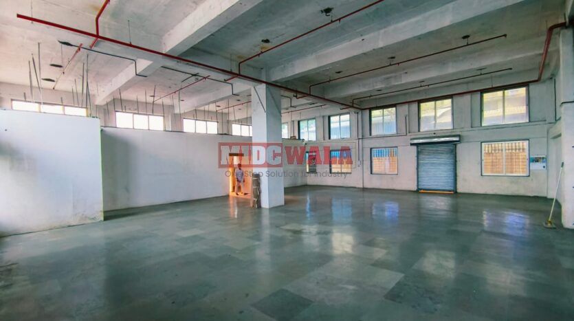 spacious and well-maintained industrial shed available for lease in Turbhe, Navi Mumbai's TTC Industrial Area. The shed features ample workspace, ample power supply, and convenient access to transportation.