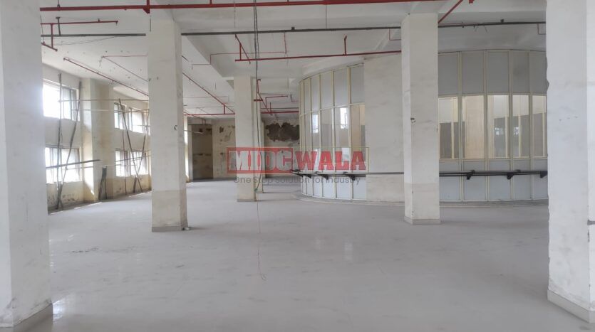 A spacious and modern RCC industrial building available for lease in Navi Mumbai's Juinagar Midc, TTC Industrial area. The building features abundant workspace, contemporary amenities, and a strategic location.