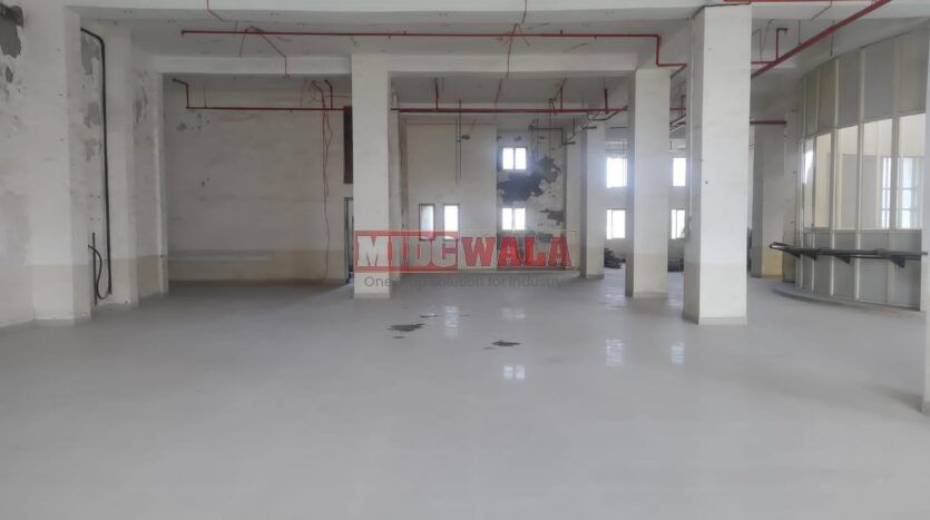 A spacious and modern RCC industrial building available for lease in Navi Mumbai's Juinagar Midc, TTC Industrial area. The building features abundant workspace, contemporary amenities, and a strategic location.