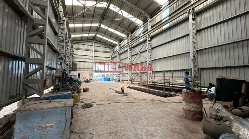 spacious and well-maintained industrial shed available for lease in Taloja, Navi Mumbai's TTC Industrial Area. The shed features ample workspace, ample power supply, and convenient access to transportation.