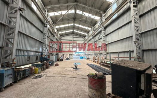 spacious and well-maintained industrial shed available for lease in Taloja, Navi Mumbai's TTC Industrial Area. The shed features ample workspace, ample power supply, and convenient access to transportation.