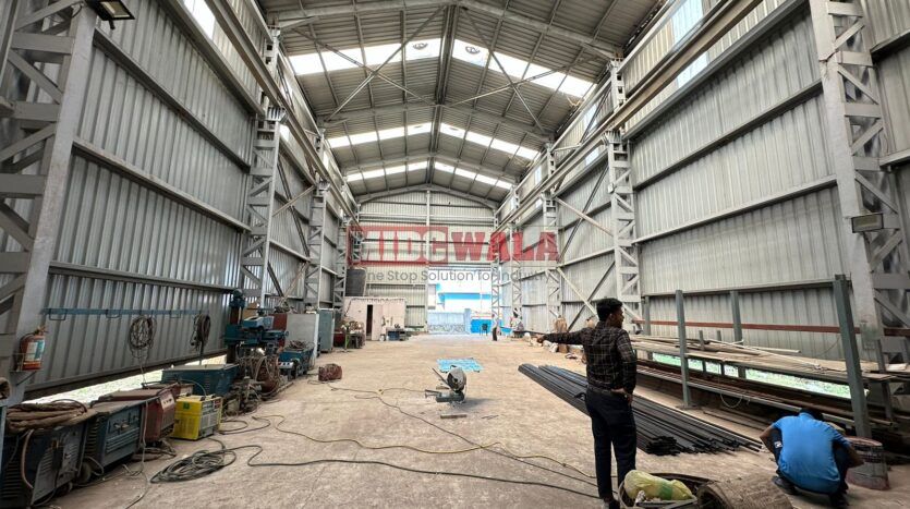 spacious and well-maintained industrial shed available for lease in Taloja, Navi Mumbai's TTC Industrial Area. The shed features ample workspace, ample power supply, and convenient access to transportation.