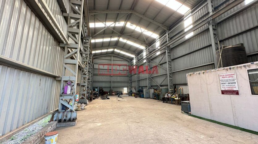 spacious and well-maintained industrial shed available for lease in Taloja, Navi Mumbai's TTC Industrial Area. The shed features ample workspace, ample power supply, and convenient access to transportation.