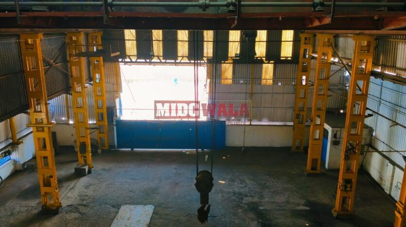 spacious and well-maintained industrial shed available for lease in Rabale, Navi Mumbai's TTC Industrial Area. The shed features ample workspace, ample power supply, and convenient access to transportation.