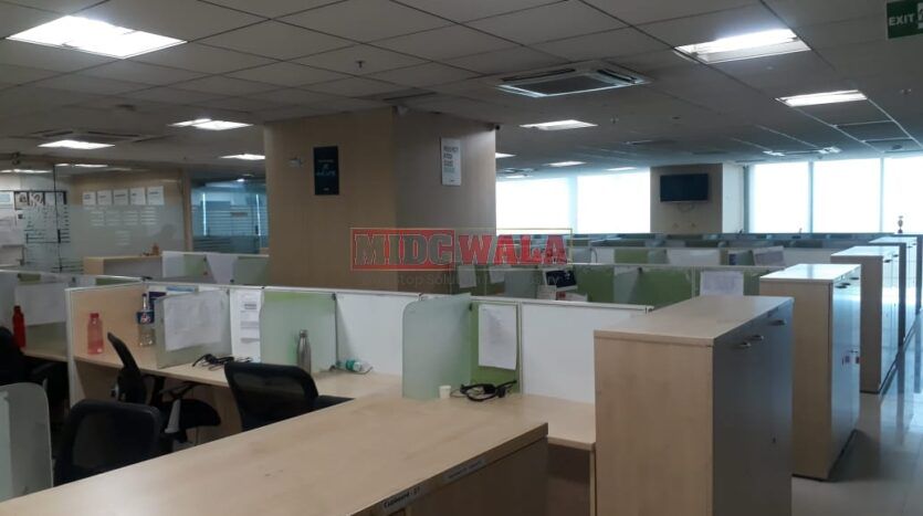 Photo of a professional office workspace with desks, chairs, and equipment, ready for immediate occupancy in Mahape, Navi Mumbai.