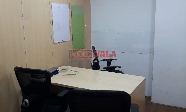 Photo of a professional office workspace with desks, chairs, and equipment, ready for immediate occupancy in Mahape, Navi Mumbai.