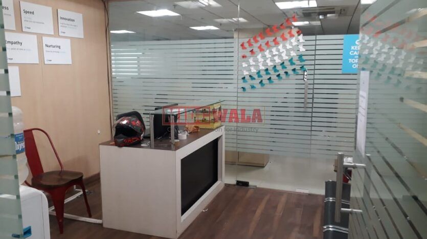 Photo of a professional office workspace with desks, chairs, and equipment, ready for immediate occupancy in Mahape, Navi Mumbai.