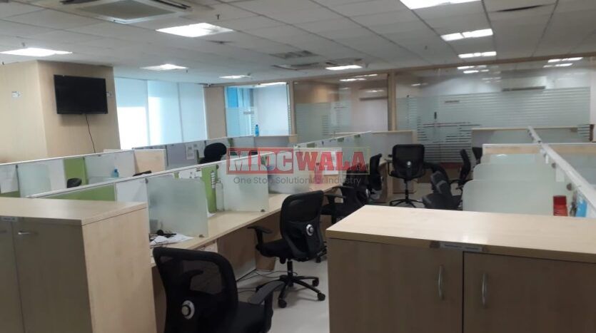 Photo of a professional office workspace with desks, chairs, and equipment, ready for immediate occupancy in Mahape, Navi Mumbai.