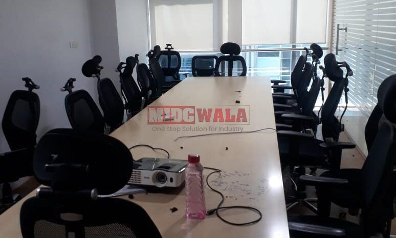 Photo of a professional office workspace with desks, chairs, and equipment, ready for immediate occupancy in Mahape, Navi Mumbai.