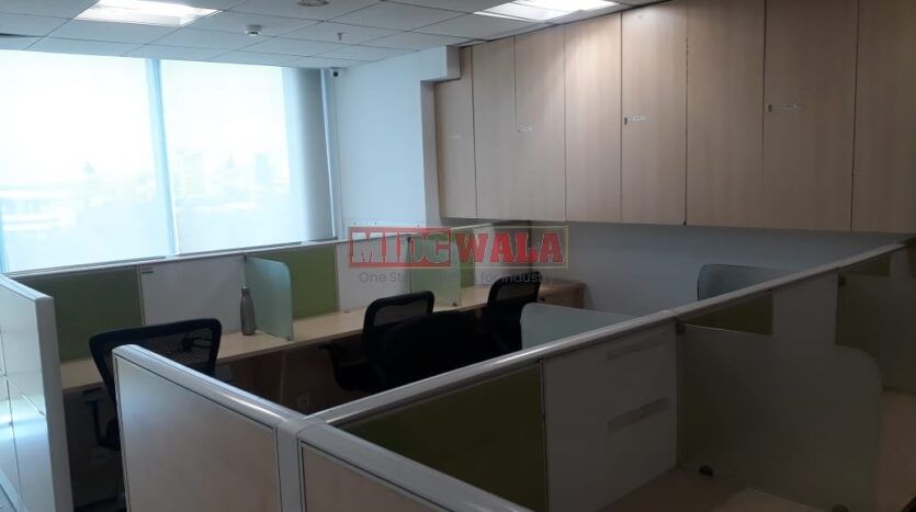 Photo of a professional office workspace with desks, chairs, and equipment, ready for immediate occupancy in Mahape, Navi Mumbai.