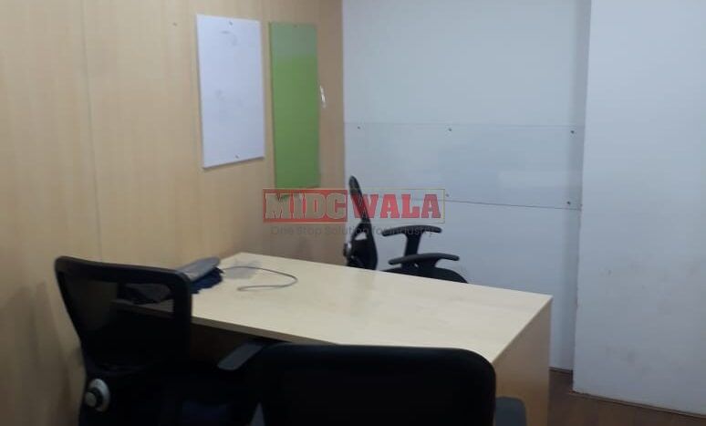 Photo of a professional office workspace with desks, chairs, and equipment, ready for immediate occupancy in Mahape, Navi Mumbai.