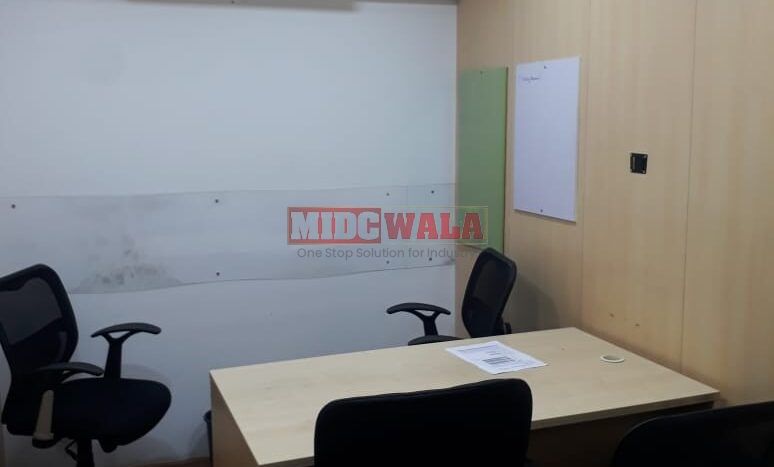 Photo of a professional office workspace with desks, chairs, and equipment, ready for immediate occupancy in Mahape, Navi Mumbai.