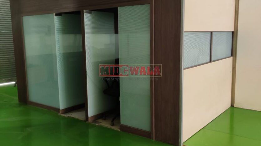 Alternative Text: "Commercial shop for lease in Taloja, Mumbai. Spacious storefront with large windows."