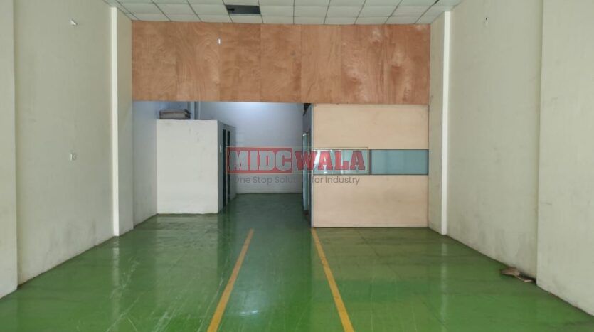 Alternative Text: "Commercial shop for lease in Taloja, Mumbai. Spacious storefront with large windows."