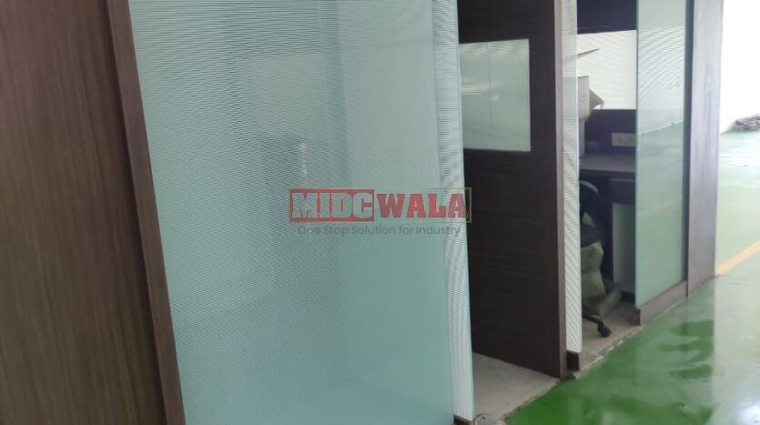 Alternative Text: "Commercial shop for lease in Taloja, Mumbai. Spacious storefront with large windows."