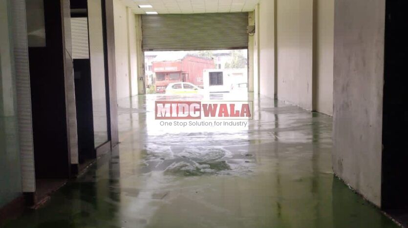 Alternative Text: "Commercial shop for lease in Taloja, Mumbai. Spacious storefront with large windows."