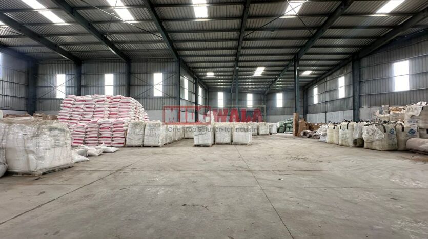 A spacious industrial warehouse with high ceilings and ample natural light, perfect for manufacturing and storage needs.